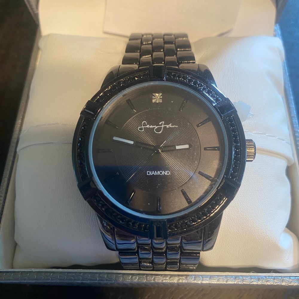 Brand new men’s watch Sean John still in box with pillow and book.